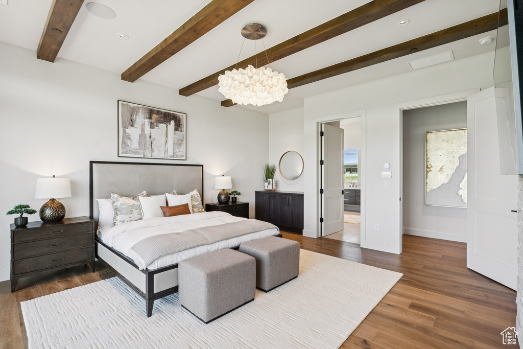 Bedroom featuring a chandelier, beam ceiling, wood finished floors, and recessed lighting