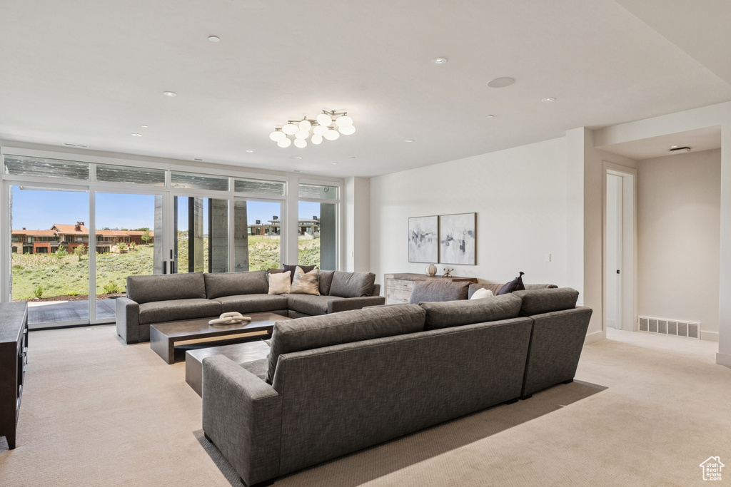 Living room with light carpet and recessed lighting