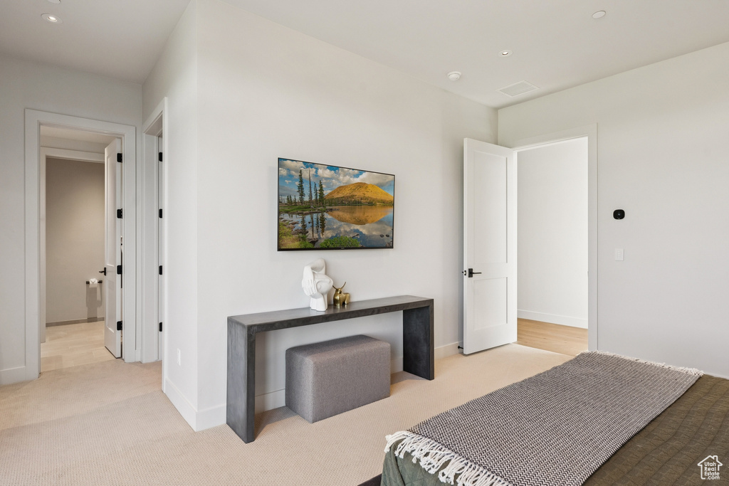 Bedroom with light colored carpet and recessed lighting