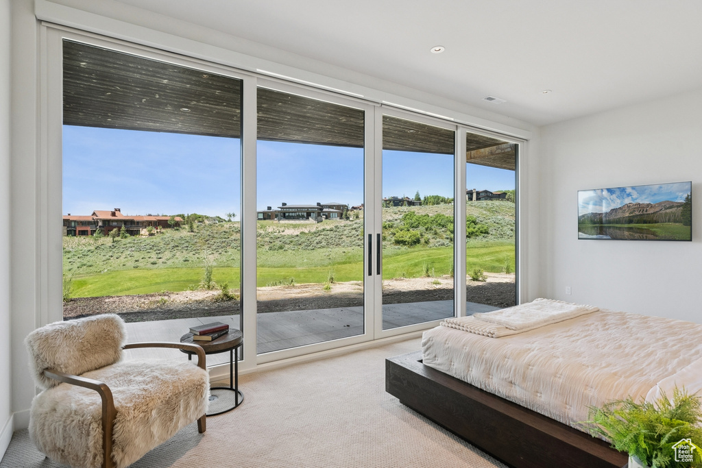 Bedroom with light carpet, access to outside, and recessed lighting
