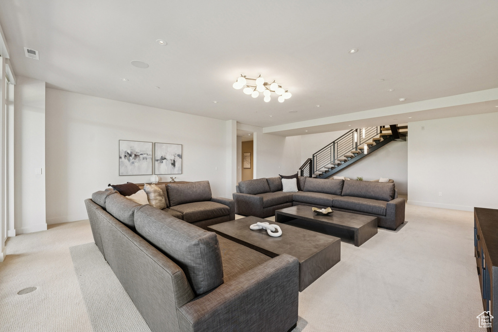 Living area with light colored carpet and stairway