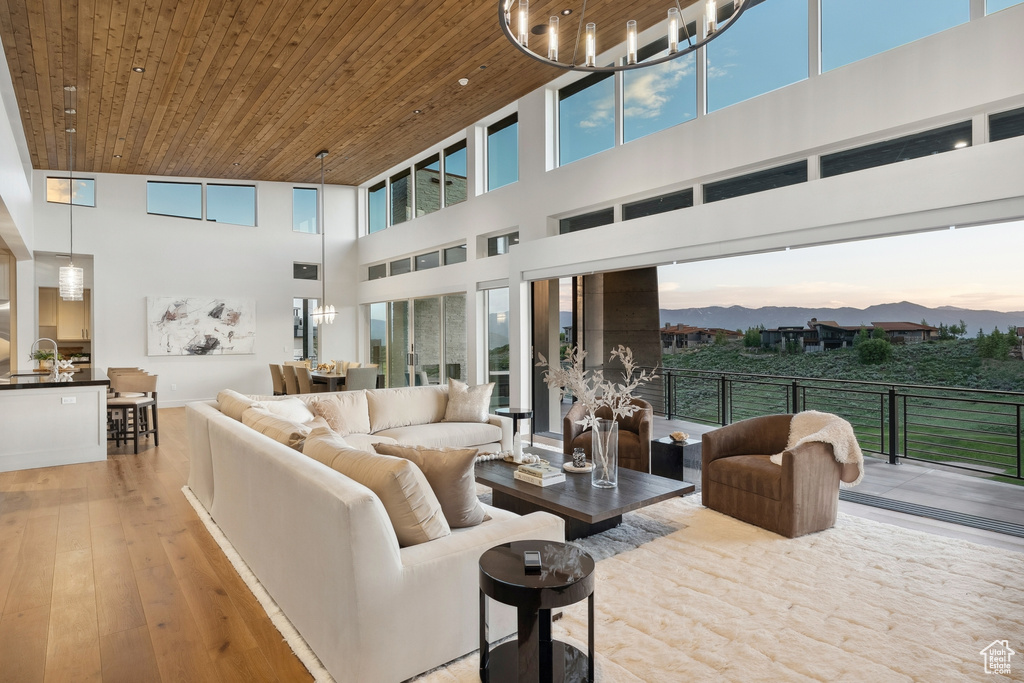 Living area with a towering ceiling, wooden ceiling, and hardwood / wood-style floors