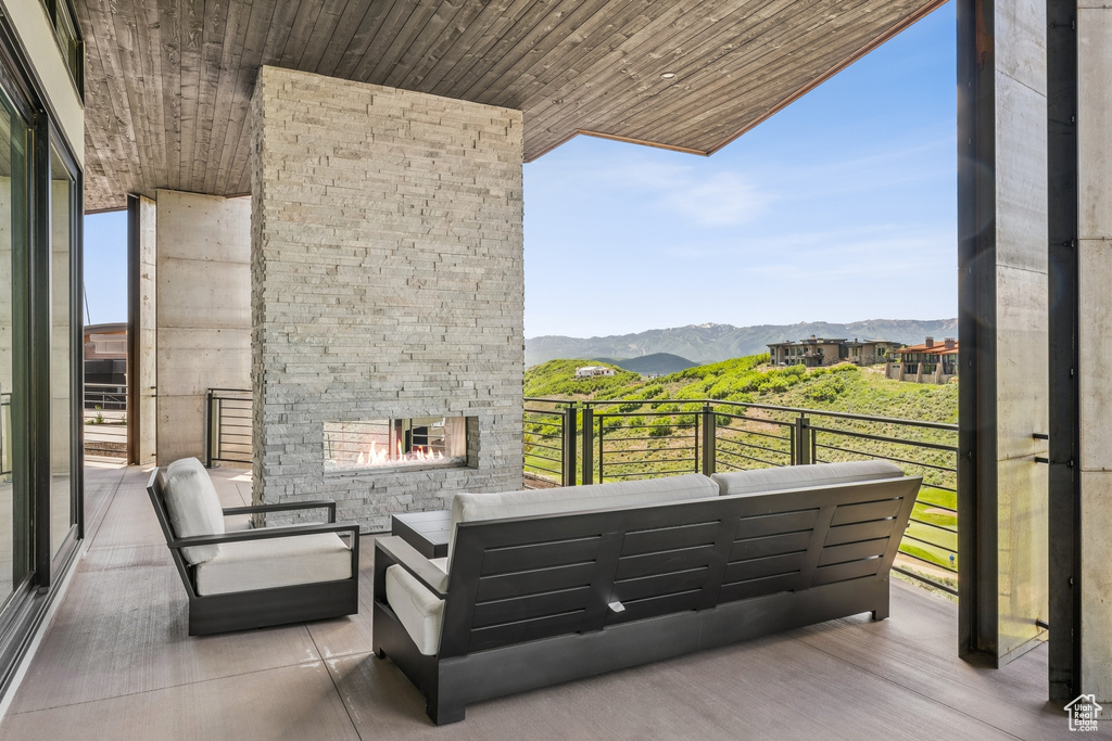 Patio / terrace featuring a mountain view and an outdoor living space with a fireplace