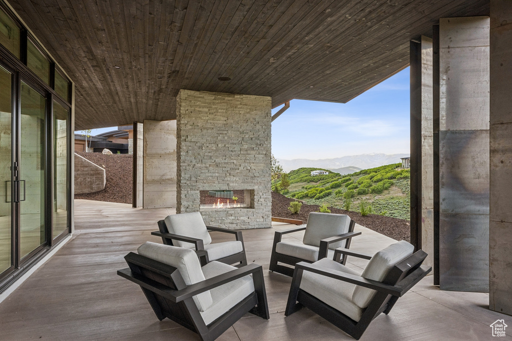 View of patio / terrace featuring a mountain view and an outdoor living space with a fireplace