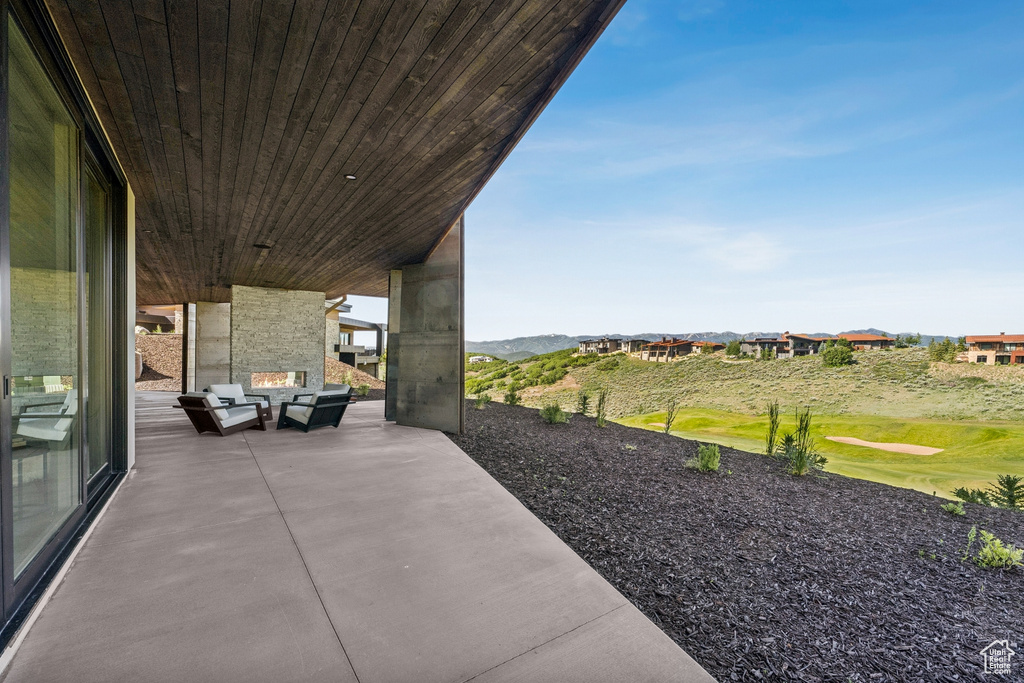 View of patio with an outdoor hangout area and a mountain view