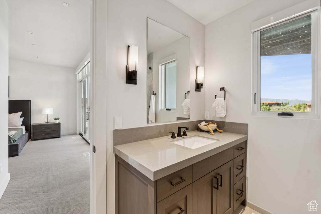 Bathroom with vanity and ensuite bath