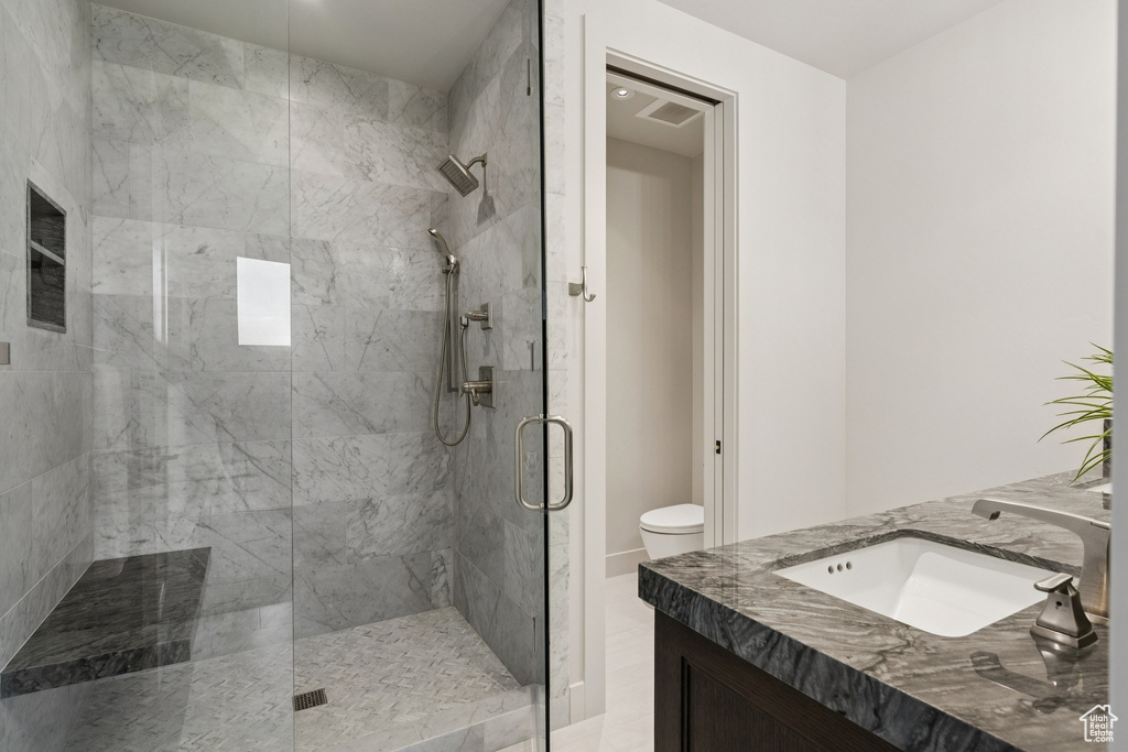 Bathroom with a stall shower and vanity