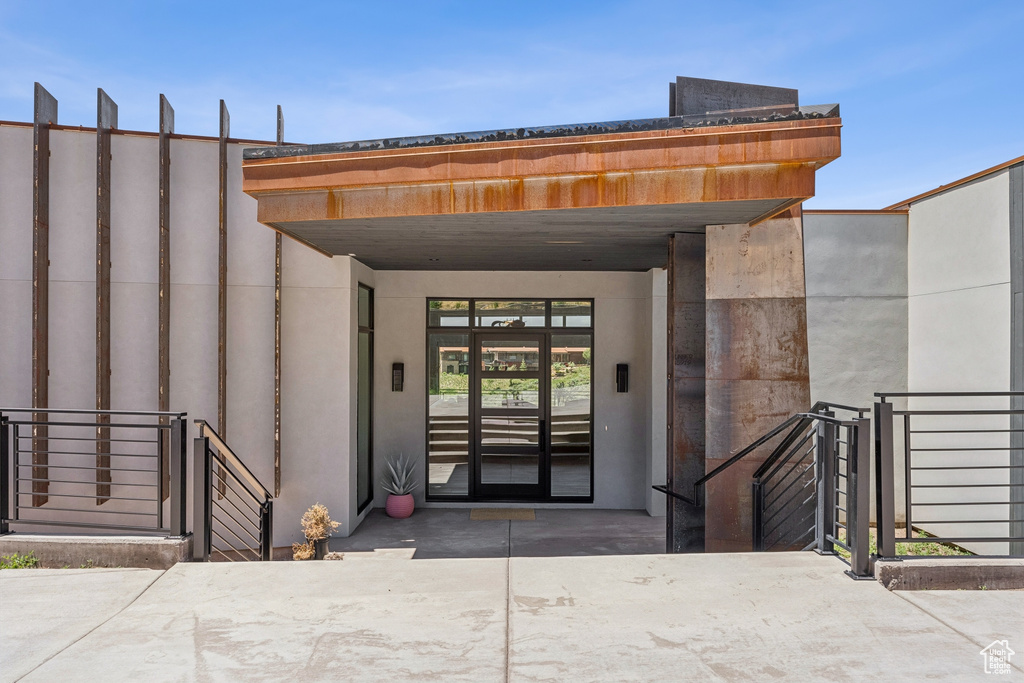 Doorway to property with stucco siding