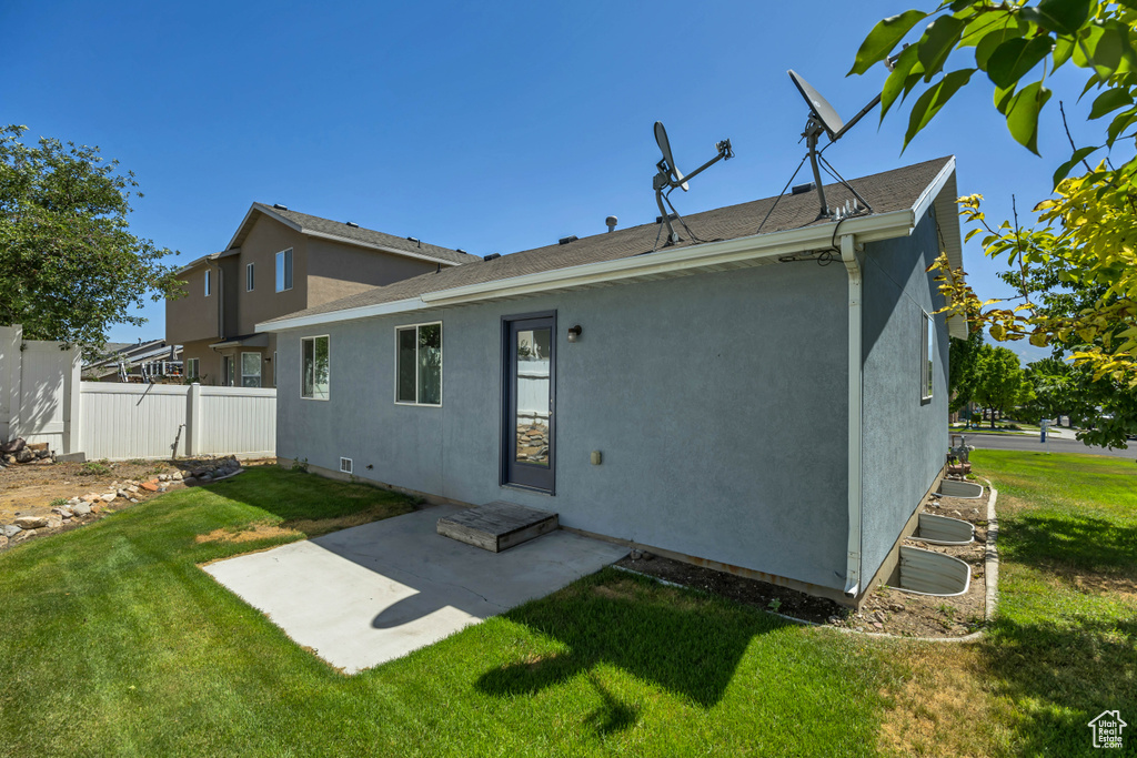 Rear view of property with stucco siding and a patio