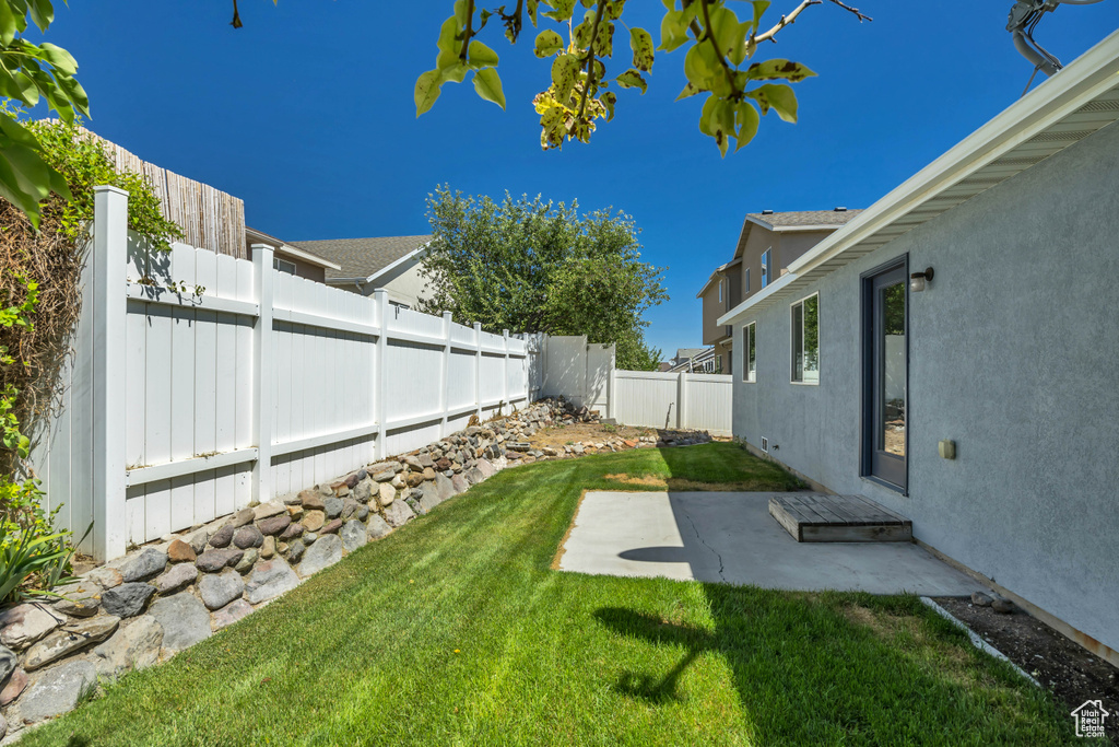 Fenced backyard with a patio