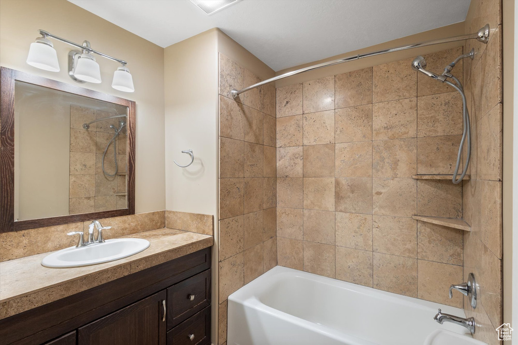 Full bath featuring shower / washtub combination and vanity