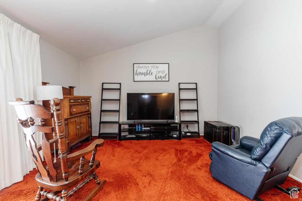 Living room with vaulted ceiling and carpet flooring