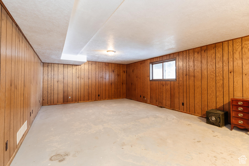 Basement featuring wood walls