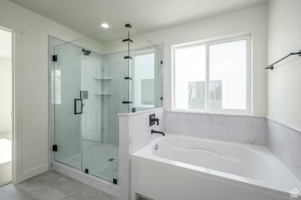 Bathroom featuring shower with separate bathtub
