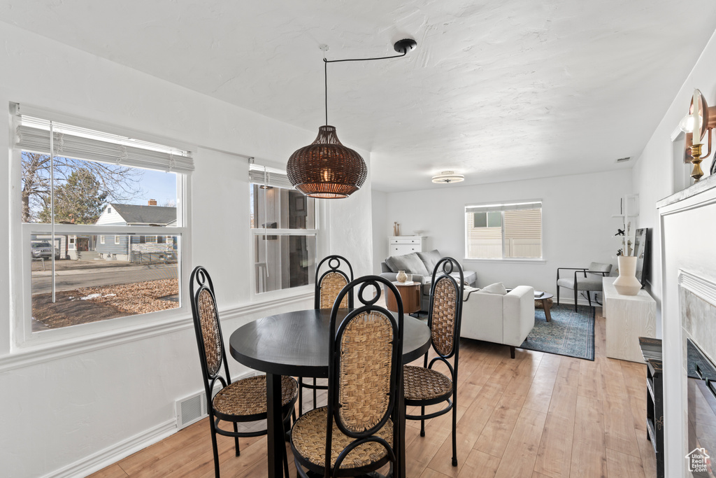 Dining room with light hardwood / wood-style floors