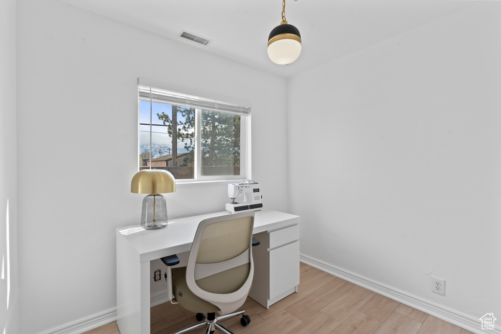 Office space featuring light wood-type flooring