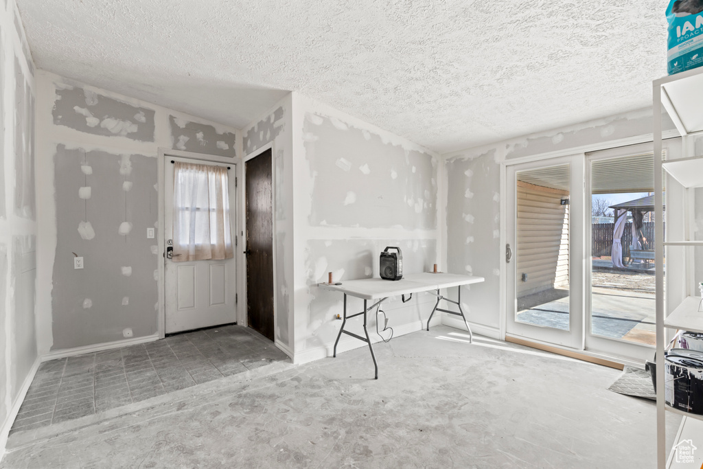 Entryway featuring plenty of natural light and a textured ceiling