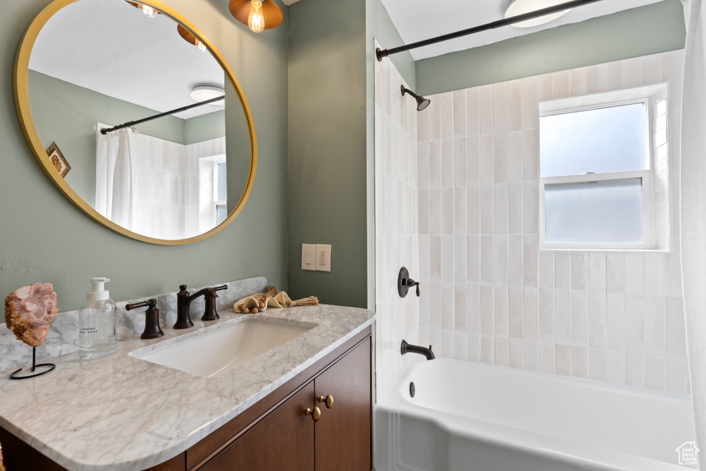 Bathroom with shower / tub combo and vanity