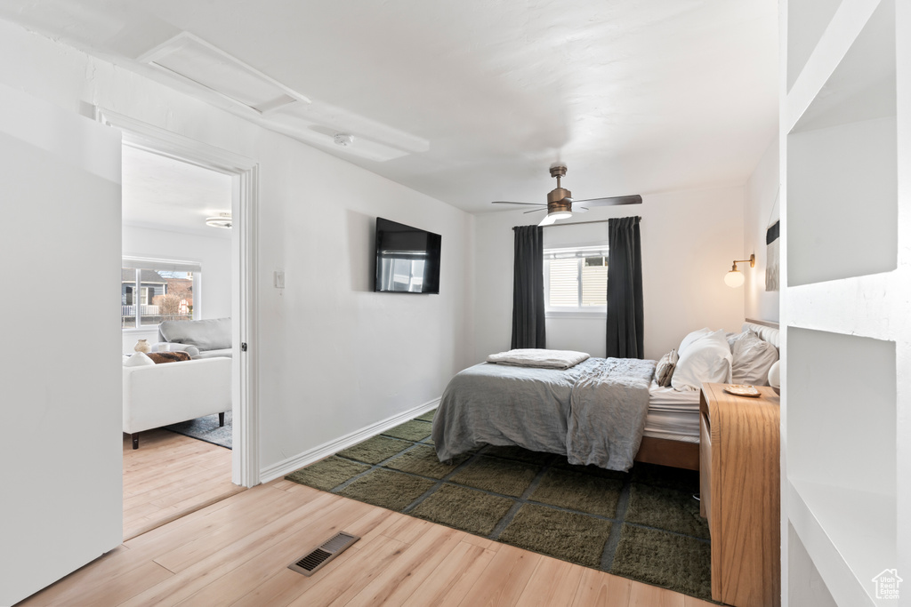 Bedroom with hardwood / wood-style floors and ceiling fan
