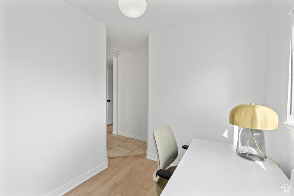 Office space with light hardwood / wood-style flooring