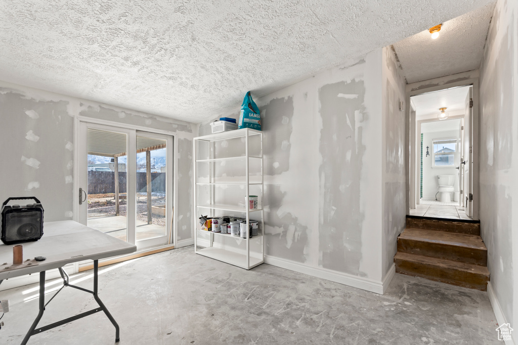 Office area with concrete floors and a textured ceiling