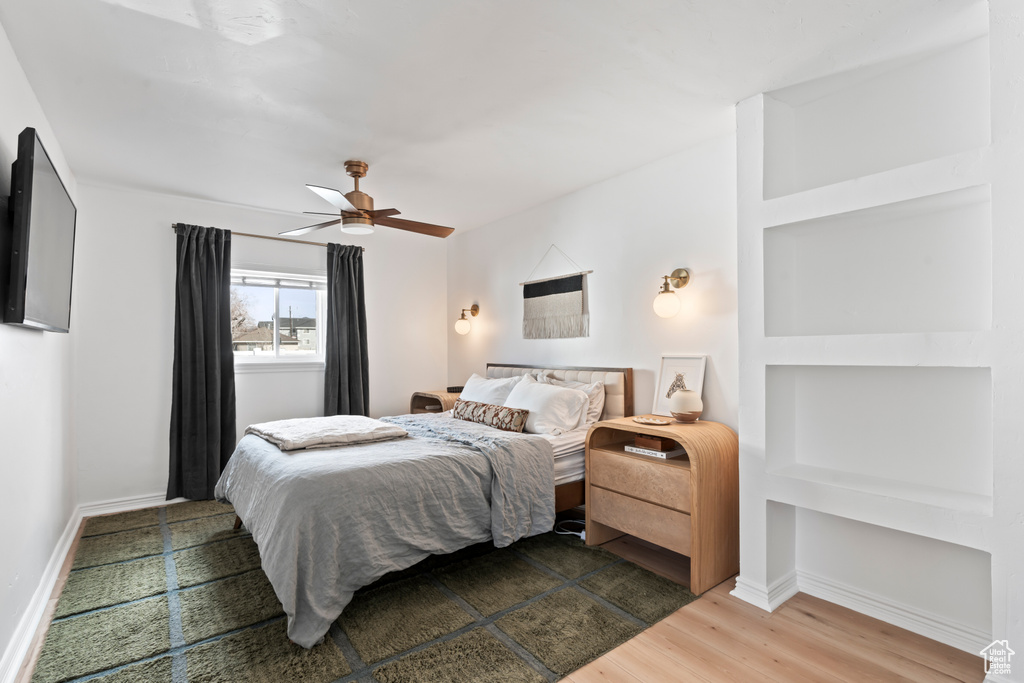 Bedroom with ceiling fan and wood-type flooring
