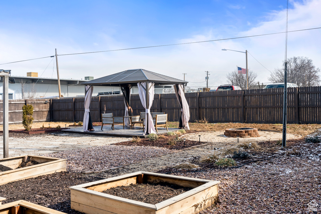 View of yard featuring a gazebo and a fire pit