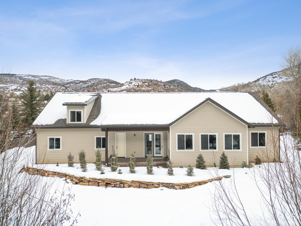 View of front of home with a porch and a mountain view