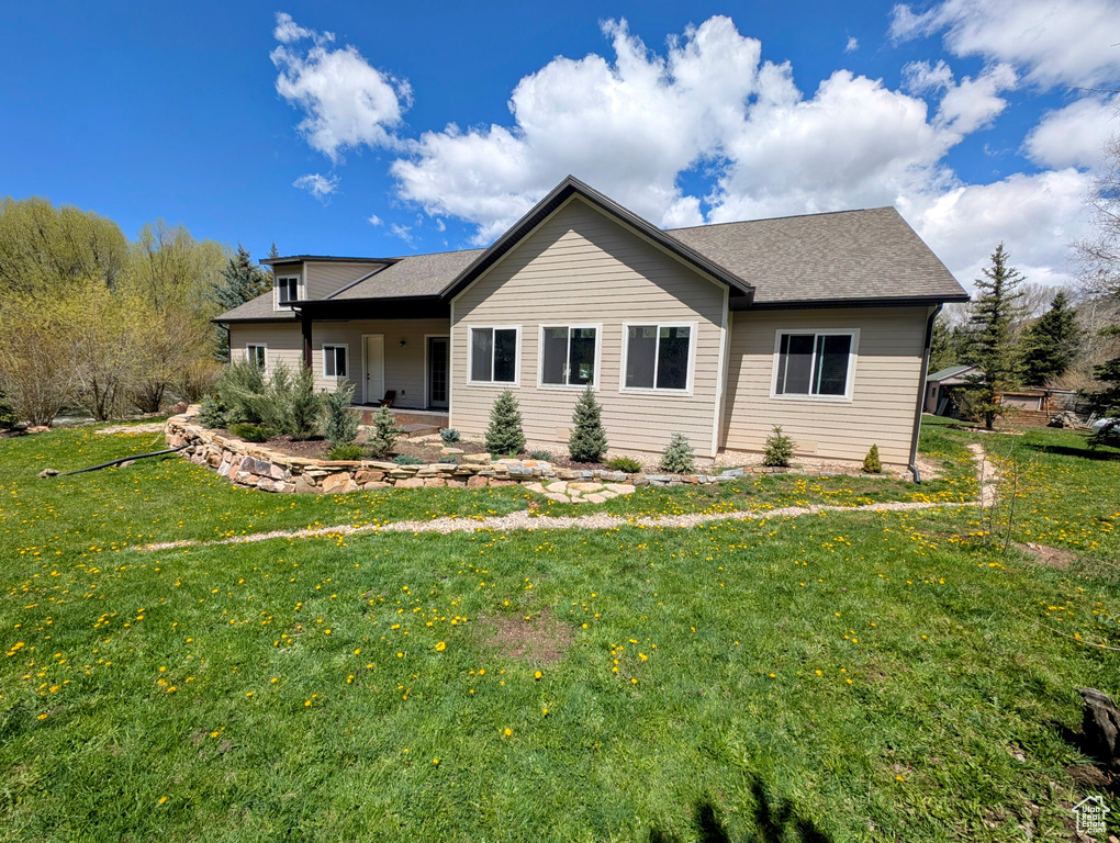 Back of property featuring a yard