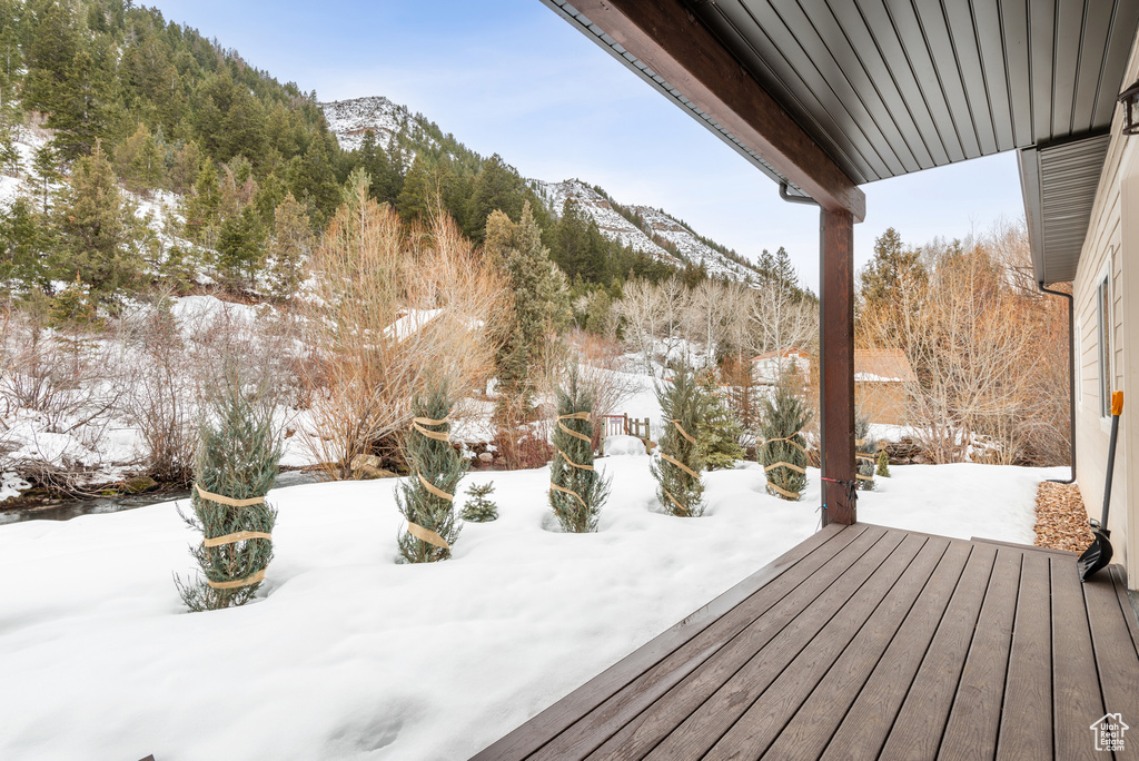 Snow covered deck with a mountain view