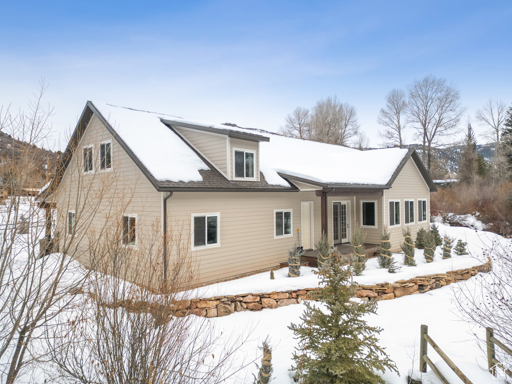 View of snow covered rear of property