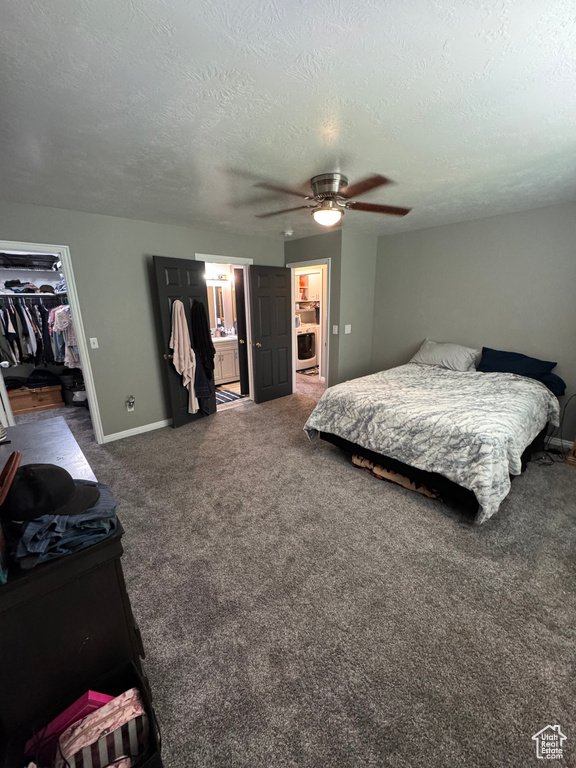 Bedroom with a walk in closet, a textured ceiling, a closet, carpet flooring, and a ceiling fan