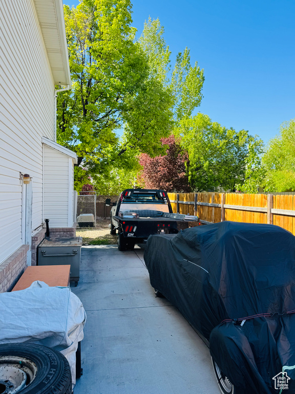 View of parking / parking lot featuring fence