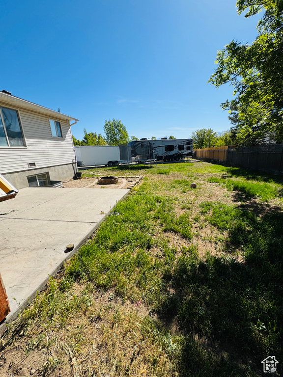 View of yard with fence, a patio area, and a trampoline