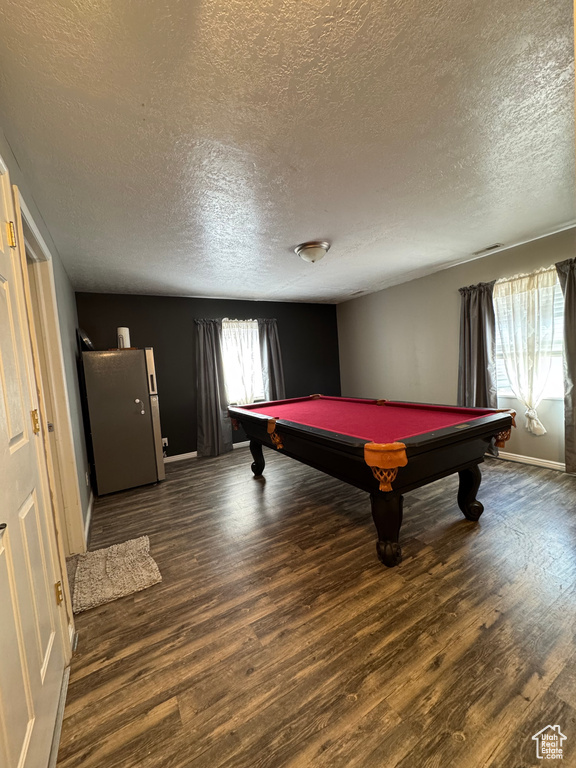 Rec room with pool table, baseboards, a textured ceiling, and wood finished floors