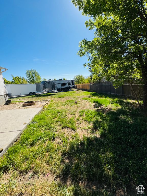 View of yard with a fenced backyard and a trampoline