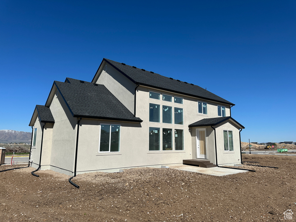 Rear view of house featuring stucco siding