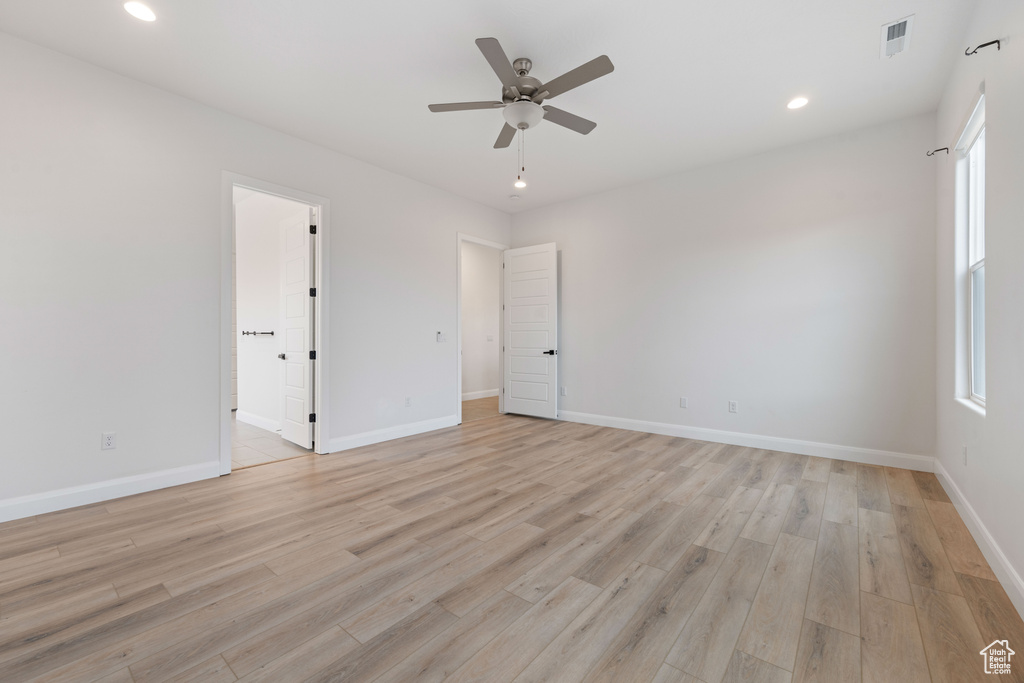 Spare room featuring ceiling fan and light hardwood / wood-style flooring