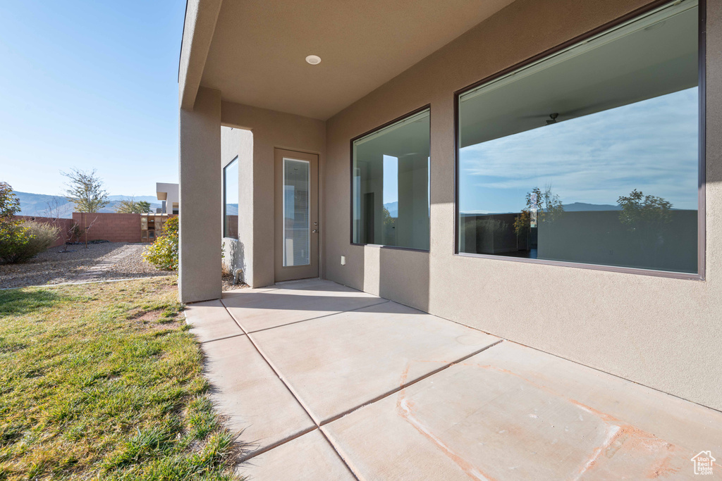 Doorway to property featuring a patio area