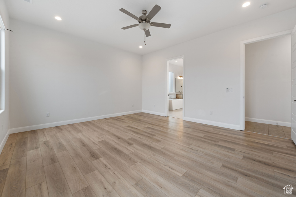 Spare room featuring ceiling fan and light hardwood / wood-style flooring