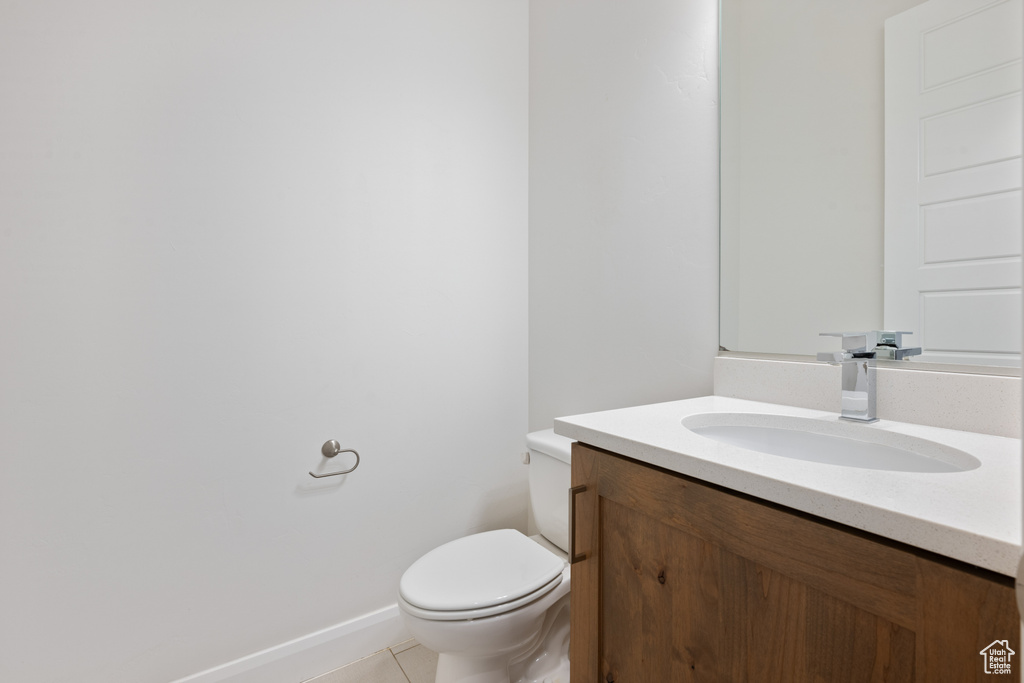 Bathroom featuring tile patterned floors, vanity, and toilet