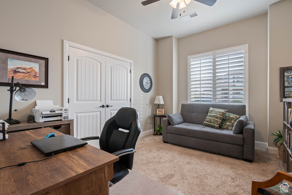 Carpeted home office with ceiling fan