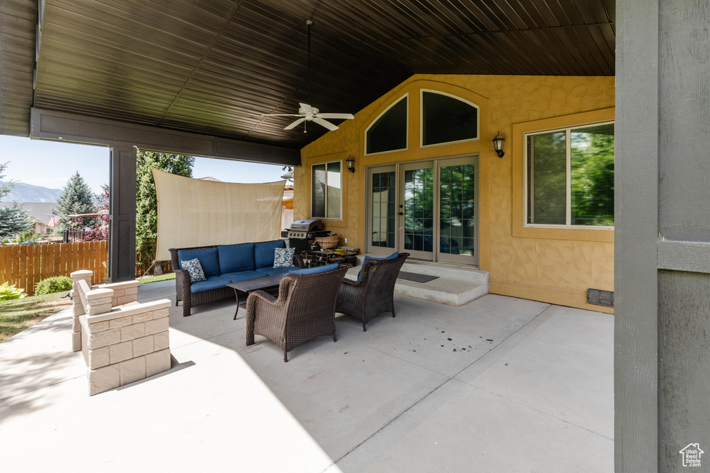 View of patio / terrace with outdoor lounge area, a ceiling fan, a mountain view, and grilling area