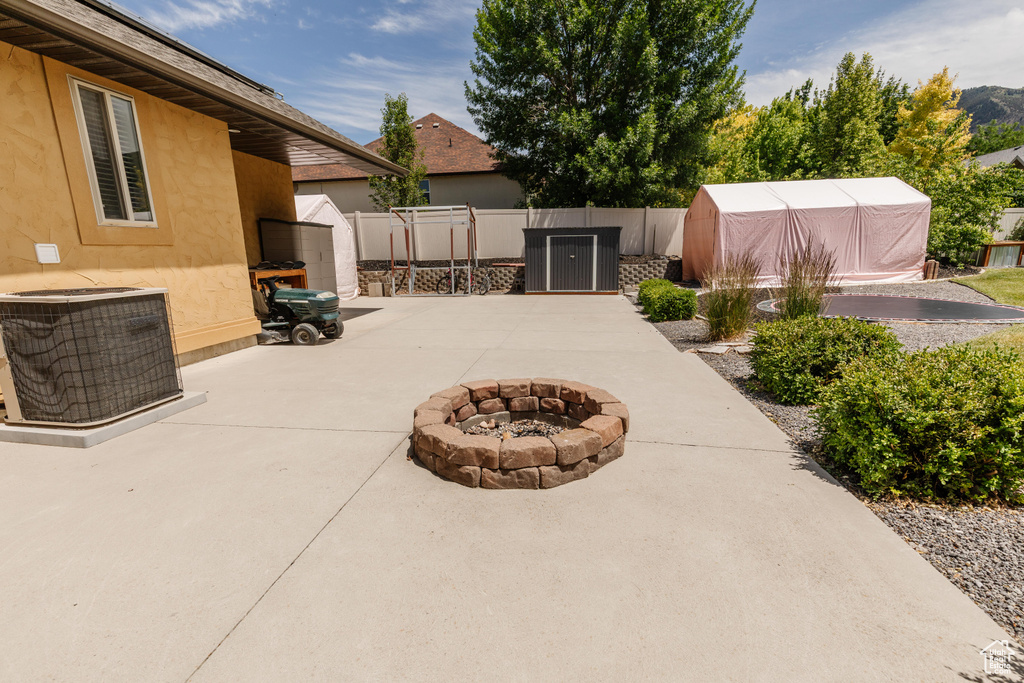 View of patio with a fire pit