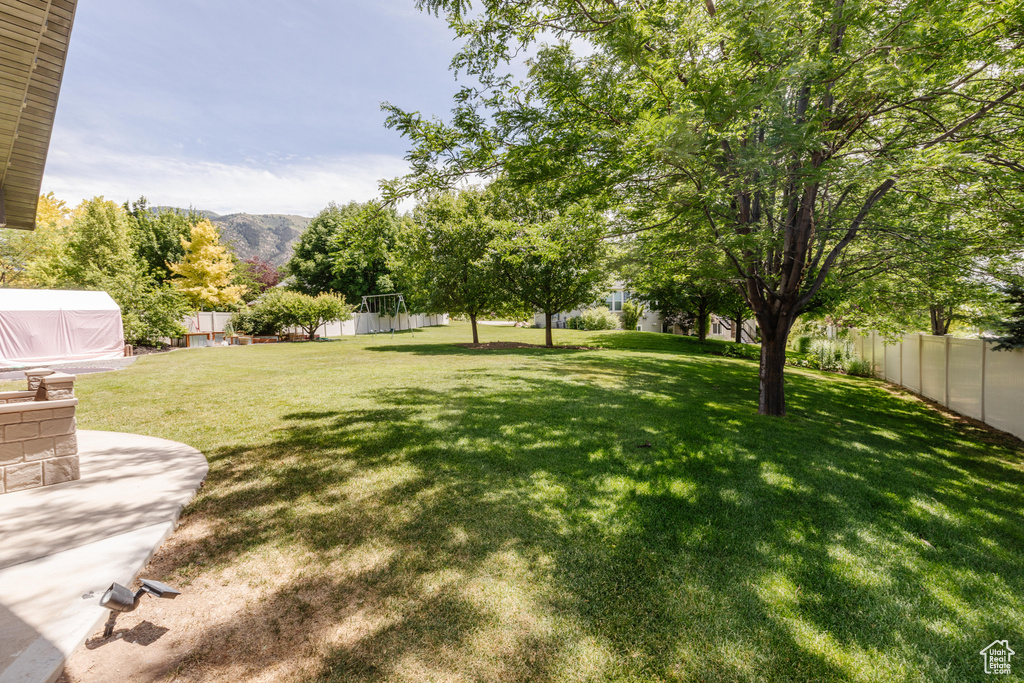 Fenced backyard with a mountain view