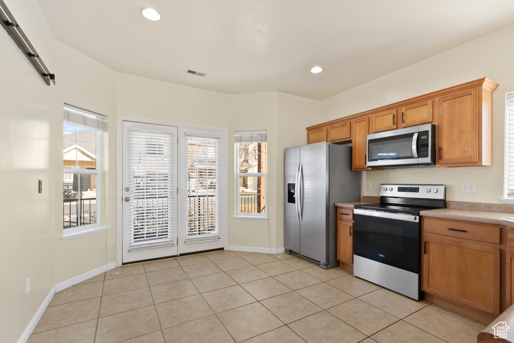 Kitchen featuring appliances with stainless steel finishes and light tile patterned floors