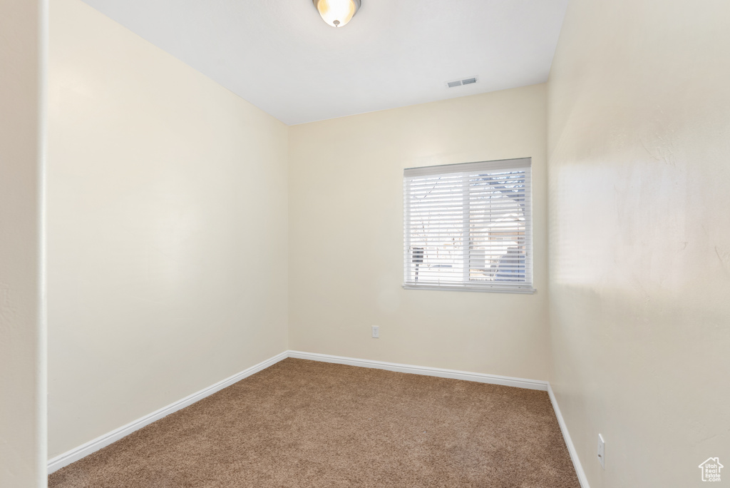 Unfurnished room featuring light colored carpet