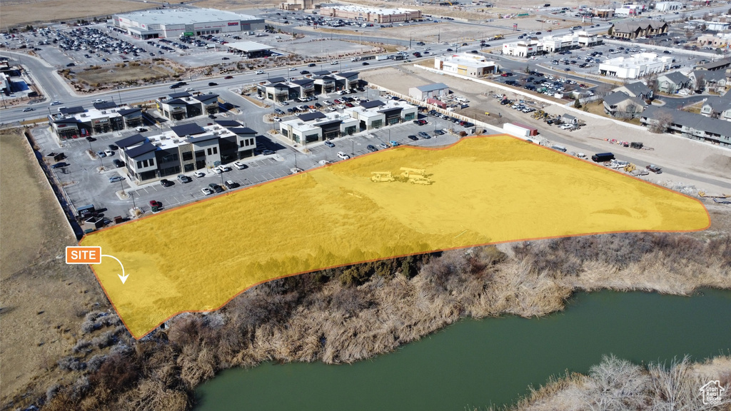 Birds eye view of property featuring a water view