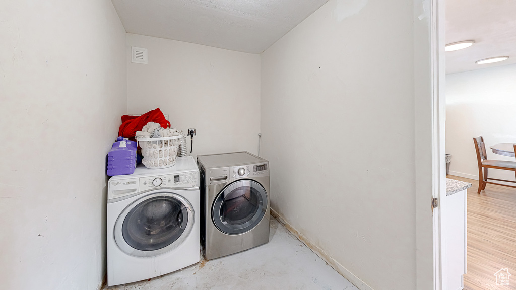 Clothes washing area featuring washer and clothes dryer