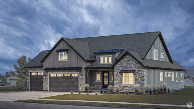 View of front of property with a garage and a front yard